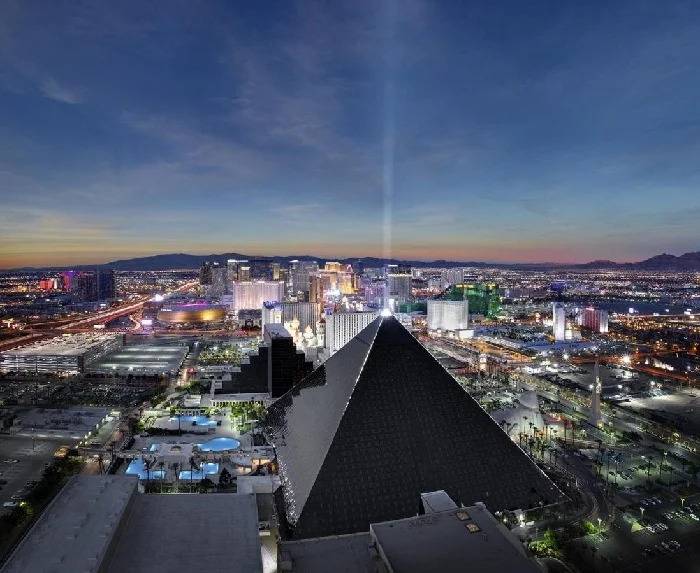 Twilight over Las Vegas with the Luxor Hotel's pyramid and light beam.